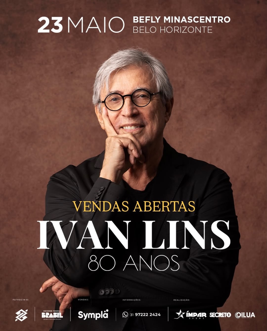 Pôster do show de Ivan Lins, em comemoração aos seus 80 anos. O músico aparece em destaque, sorrindo e usando óculos. O evento acontecerá no dia 23 de maio, no Befly Minascentro, em Belo Horizonte. Abaixo, o texto informa "Vendas Abertas" pela plataforma Sympla.