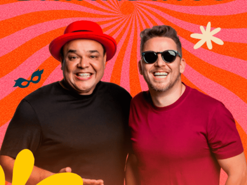 Cartaz vertical com estética vibrante e retrô, predominantemente nas cores laranja, rosa e amarelo. O fundo apresenta um efeito de "raios de sol" (sunburst) que converge para o centro. Dois homens sorridentes aparecem em destaque na metade inferior.