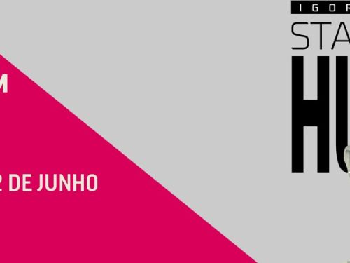 Banner de evento com fundo rosa e cinza à esquerda e foto à direita. Texto em destaque: “Igor Guimarães - Stand Up de Humor” e as datas “11 e 12 de junho”. Na imagem, um homem está com um dos olhos fechados em piscadela sob o filtro cinza..