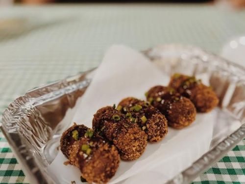 Bandeja com cinco quitutes enfileirados.