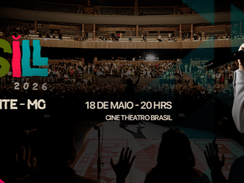 Banner horizontal mostrando ao fundo um teatro lotado sob luzes quentes. À direita, em primeiro plano, o cantor Eli Soares sorri enquanto segura um microfone. À esquerda, o logotipo colorido da "Turnê BRASIL 2026". Abaixo, as informações do show: "Belo Horizonte - MG", data e horário: "18 de Maio - 20 hrs" e o local: "Cine Theatro Brasil". No canto inferior esquerdo, há um detalhe em rosa vibrante.