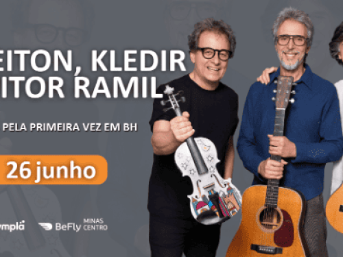 O anúncio apresenta um fundo cinza com marcas d'água das silhuetas dos próprios artistas. À direita, os três músicos aparecem sorridentes, em pé e lado a lado, segurando seus respectivos instrumentos acústicos: um violino decorado com desenhos coloridos, um violão e um violão de náilon menor. À esquerda, o texto em letras garrafais brancas destaca o nome do trio e a frase "JUNTOS PELA PRIMEIRA VEZ EM BH". Logo abaixo, a data "26 junho" ganha destaque dentro de um botão oval laranja, com os logotipos da Symp