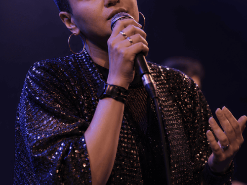 Foto da cantora Camila Lopez cantando no palco