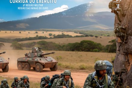 Imagem de homens usando farda, com armas na mão, com tanque da guerra atras