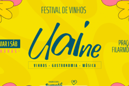 Cartaz digital com fundo amarelo vibrante e ilustrações coloridas de flores e garrafas de vinho. No centro, destaca-se a palavra "Uaine" em letras cursivas azuis. Acima, o título "FESTIVAL DE VINHOS" e, abaixo, os pilares do evento: Vinhos, Gastronomia e Música.